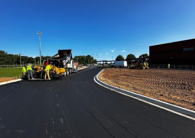 SMI Paving crew laying asphalt on a commercial access road in Charlotte NC