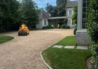 asphalt paving contractors working on house driveway